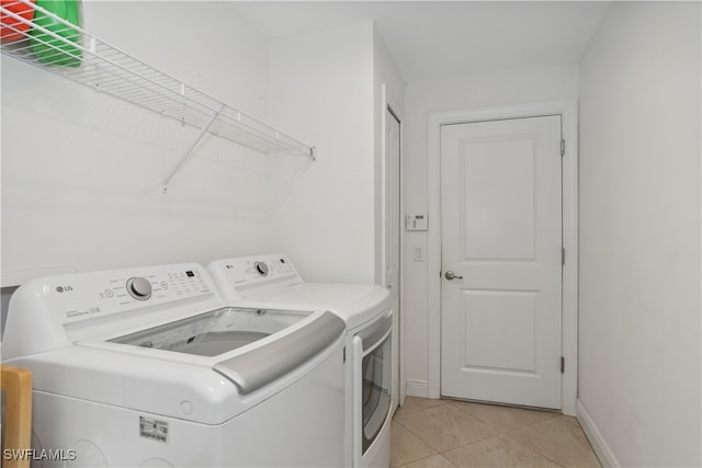 176 Venus Cay Cay, Naples, FL 34114 - laundry room with washing machine and dryer and light tile patterned floors