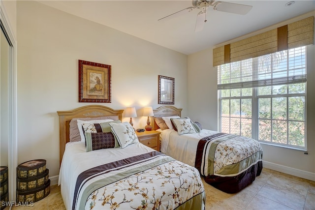 tiled bedroom featuring a closet and ceiling fan