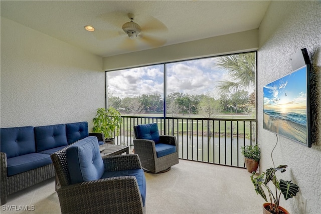 sunroom / solarium featuring ceiling fan