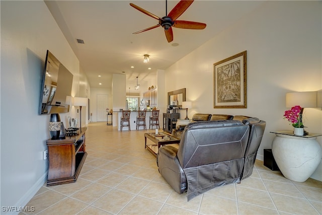 living room featuring ceiling fan and light tile patterned floors