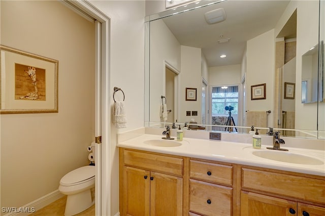 bathroom with vanity, toilet, and tile patterned flooring