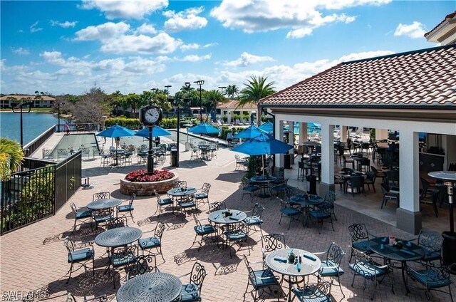 exterior space featuring a water view and a patio