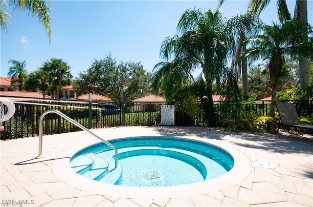 view of pool with a hot tub and a patio