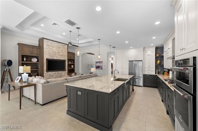 kitchen with white cabinetry, appliances with stainless steel finishes, and a tray ceiling