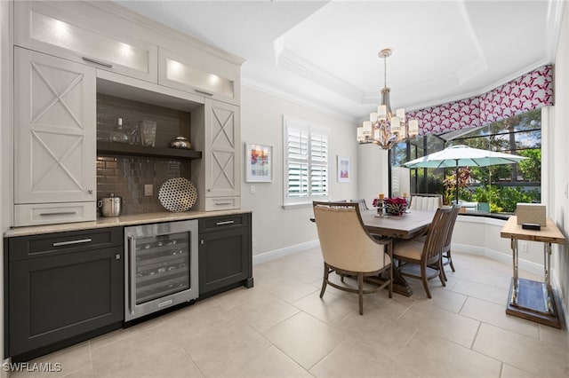 tiled dining area featuring crown molding, a healthy amount of sunlight, bar area, and wine cooler