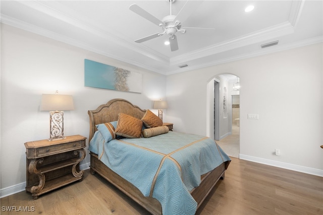 bedroom featuring crown molding, ceiling fan, and a tray ceiling