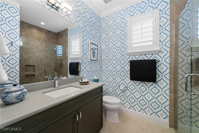 bathroom with tile patterned flooring, ornamental molding, vanity, walk in shower, and toilet