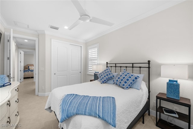 tiled bedroom with ornamental molding, a closet, and ceiling fan