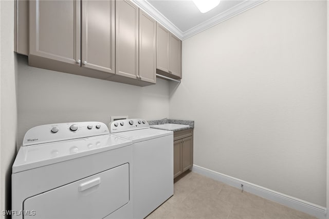 washroom featuring crown molding, cabinets, sink, and washing machine and dryer