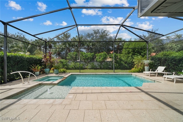 view of pool with an in ground hot tub, a patio, and glass enclosure