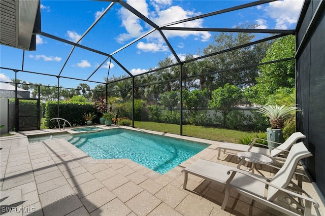 view of pool with an in ground hot tub, a patio, a yard, and glass enclosure