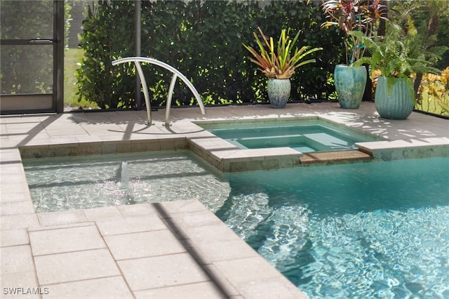 view of pool with an in ground hot tub