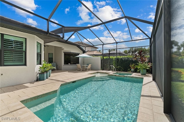 view of swimming pool featuring an in ground hot tub, a lanai, and a patio