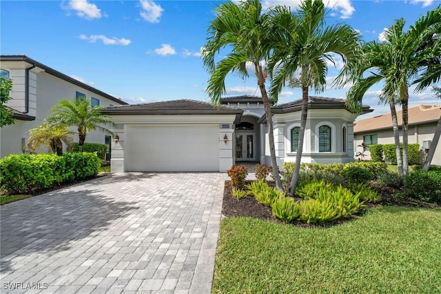 view of front of property with a garage and a front lawn