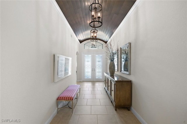 doorway to outside featuring a chandelier, light tile patterned floors, wood ceiling, crown molding, and french doors