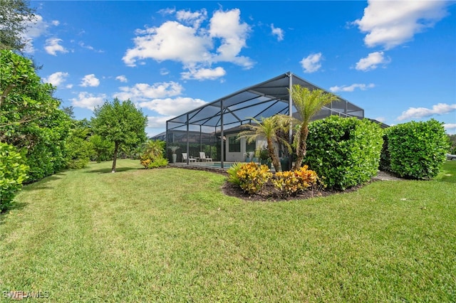 view of yard featuring glass enclosure