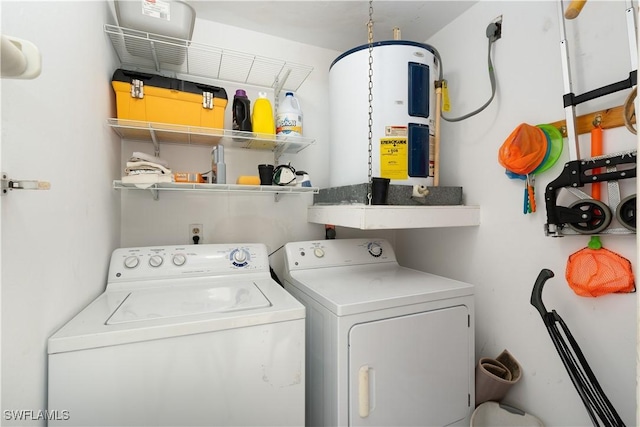 washroom with electric water heater and separate washer and dryer