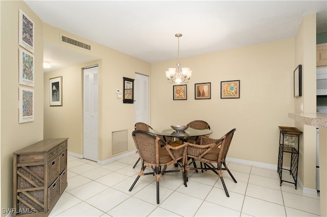 dining space featuring light tile patterned floors and a chandelier