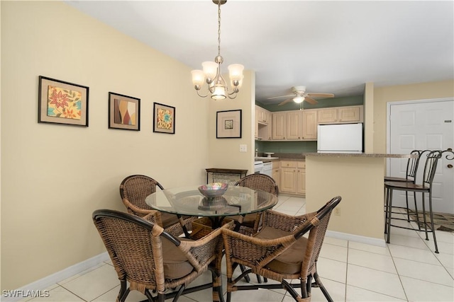 tiled dining space with ceiling fan with notable chandelier