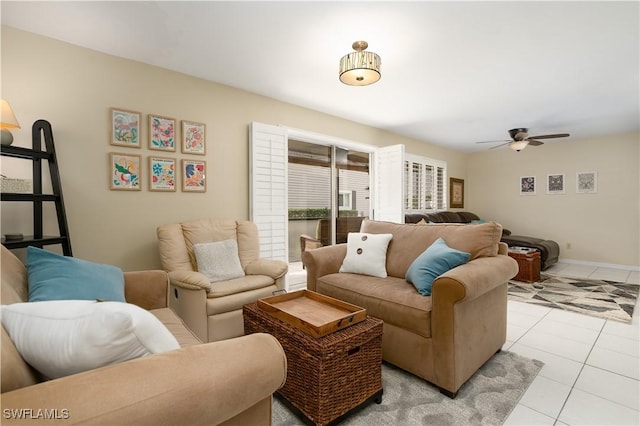 living room featuring ceiling fan and light tile patterned flooring