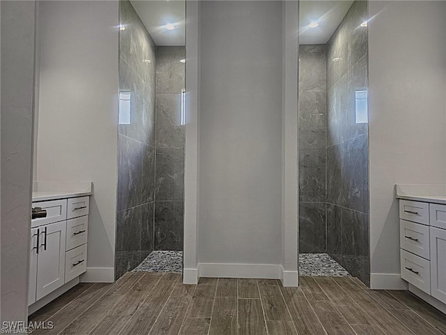 bathroom with vanity and a tile shower