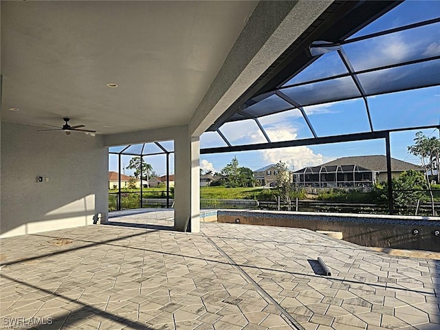 view of patio / terrace with ceiling fan and glass enclosure