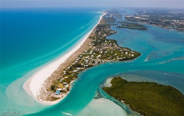 birds eye view of property with a beach view and a water view