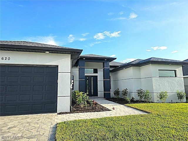 view of front facade with a garage and a front lawn