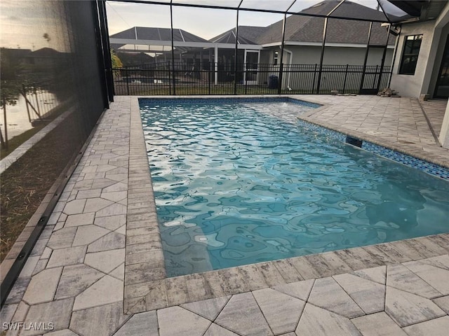 view of pool with a lanai and a patio