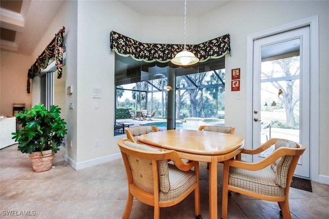 8921 Crown Colony Blvd, Fort Myers, FL 33908 - dining area with a sunroom, baseboards, and light tile patterned floors
