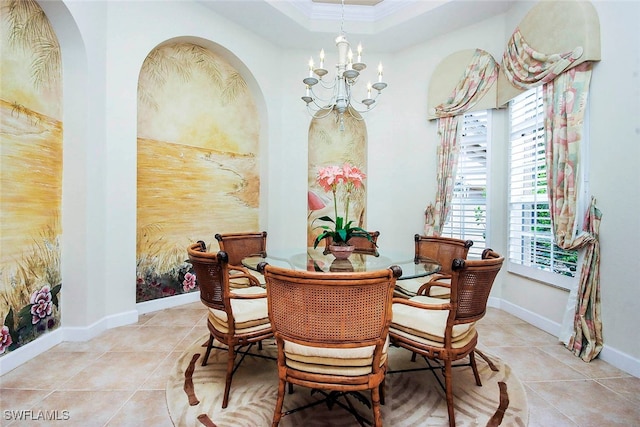 dining space with ornamental molding, light tile patterned floors, and a chandelier