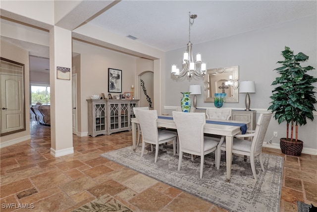 dining area with an inviting chandelier