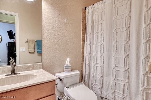 bathroom featuring vanity, toilet, and walk in shower