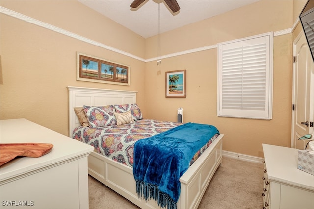 bedroom featuring ceiling fan and light carpet