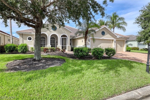 view of front facade featuring a garage and a front lawn