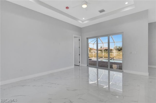 empty room featuring a raised ceiling