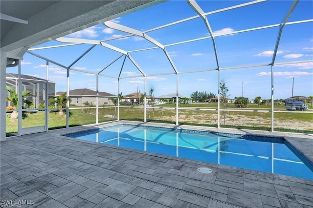 view of swimming pool with a patio and glass enclosure