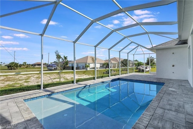 view of swimming pool featuring a patio area and a lanai