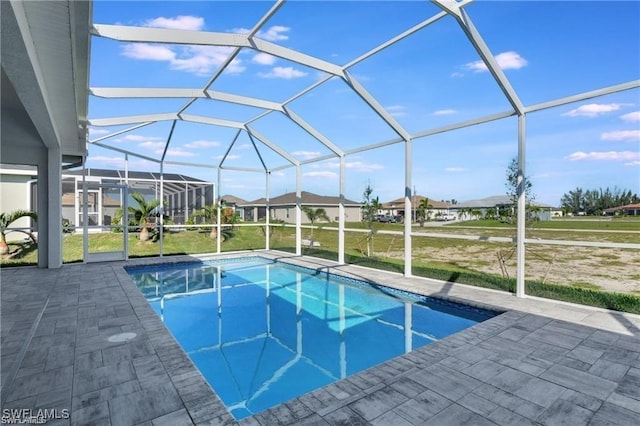 view of swimming pool with a patio area and a lanai