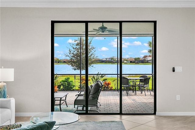 doorway featuring ceiling fan, light tile patterned floors, crown molding, and a water view