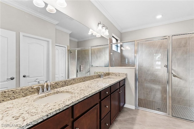 bathroom with vanity, tile patterned floors, a shower with shower door, and ornamental molding