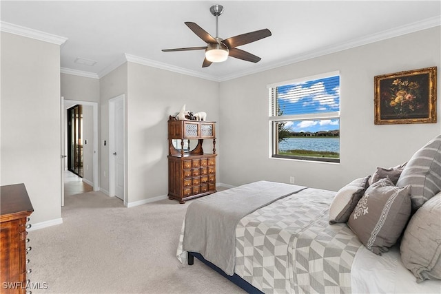 carpeted bedroom with ceiling fan and ornamental molding