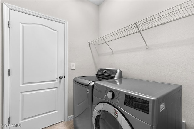 laundry room featuring washer and dryer and tile patterned floors