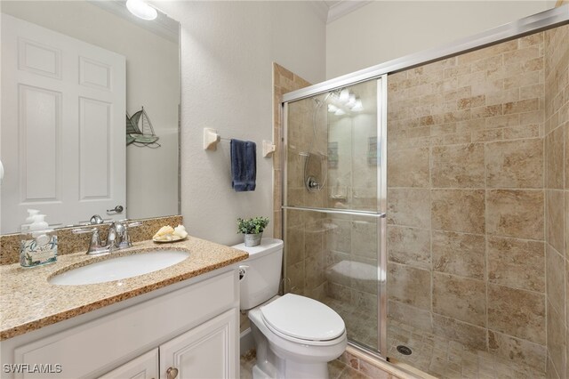 bathroom with vanity, toilet, and an enclosed shower