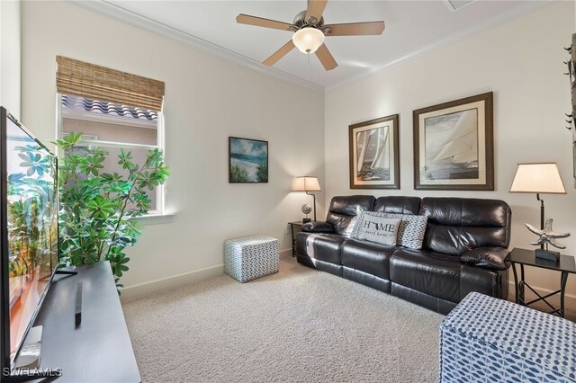 living room featuring ceiling fan, ornamental molding, and carpet floors