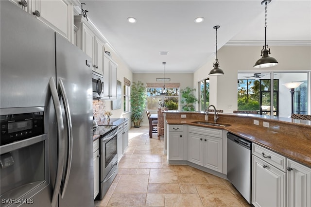 kitchen with white cabinetry, sink, pendant lighting, and appliances with stainless steel finishes