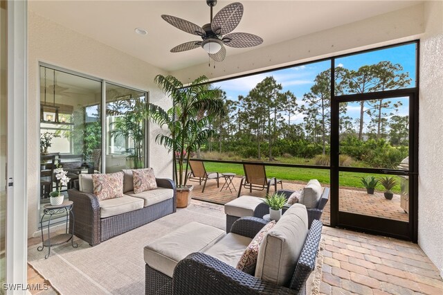 sunroom featuring plenty of natural light and ceiling fan