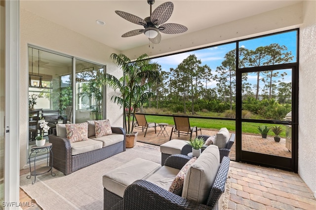 sunroom featuring ceiling fan