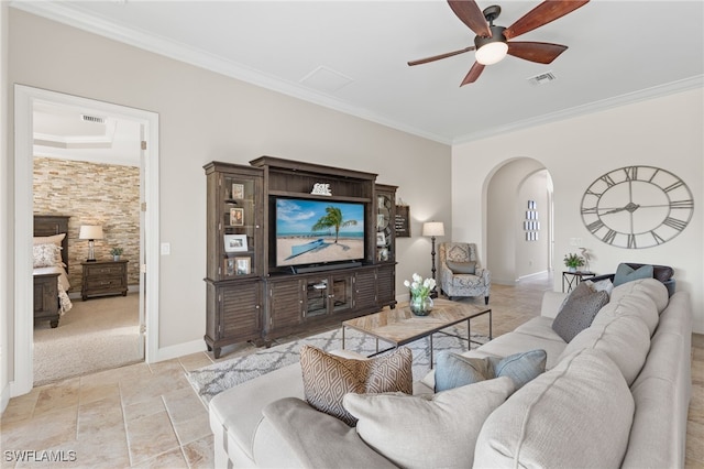 living room with ceiling fan and ornamental molding