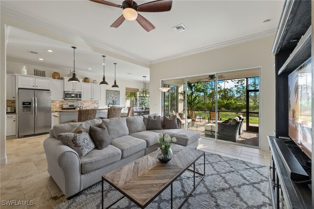 living room featuring ceiling fan and crown molding